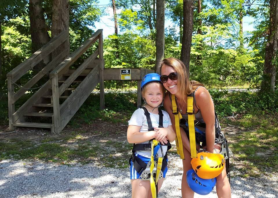 Mother and daughter in zipline harness