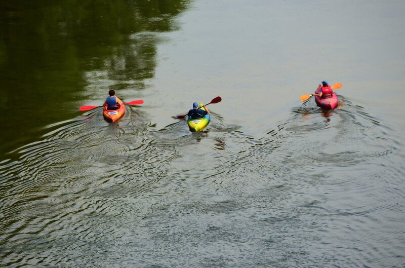 Kayaks paddling on the river