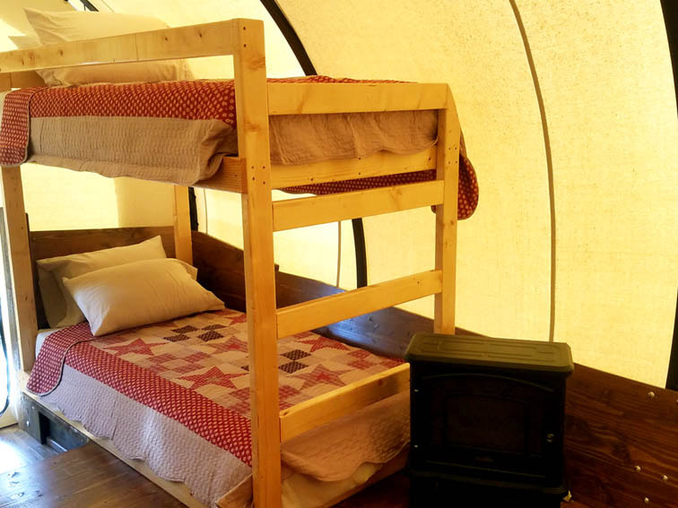 Pictured are the twin bunk beds set up in our Covered Wagons. 