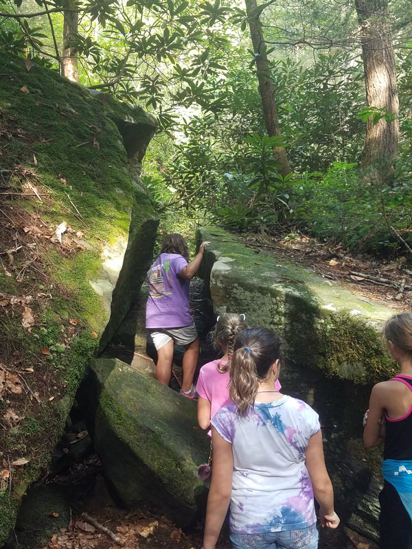 Kids hiking through rocks