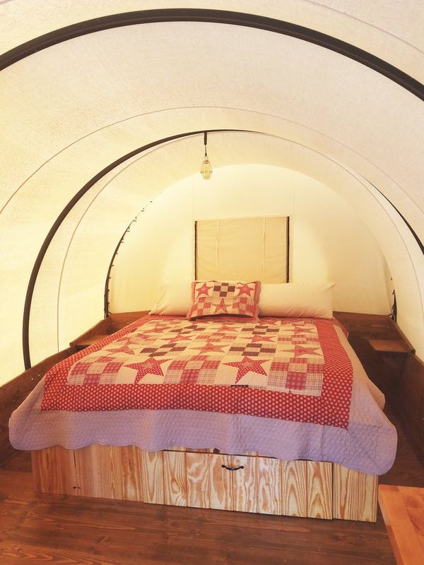 Shown in this photo is the King size bed located in our Covered Wagons. 