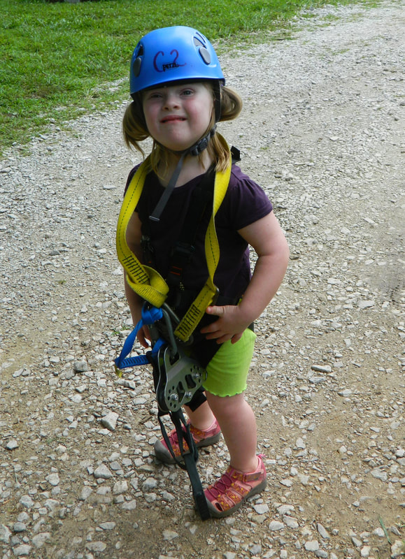 little girl in zipline gear
