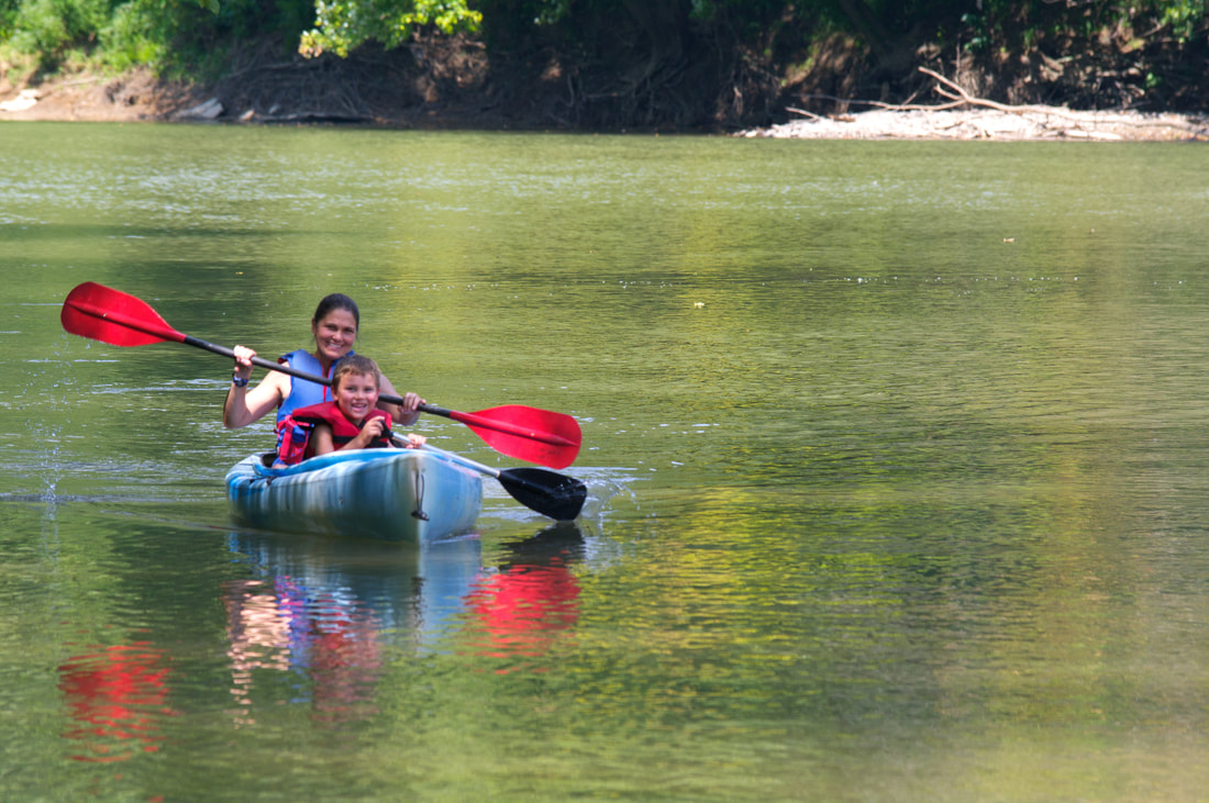 Woman and Kid kayaking in tandem kayak