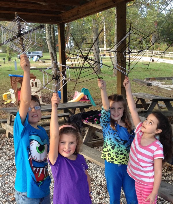 Kids showing off crafts made during our campground activities program